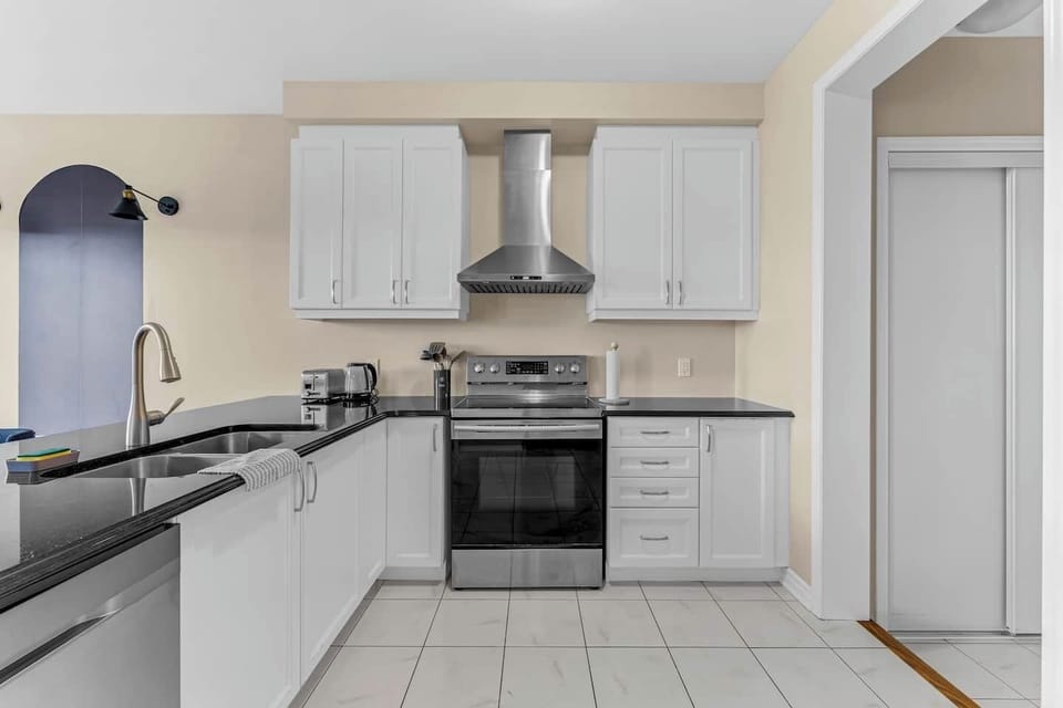 Stylish kitchen with modern appliances, sleek counters, and plenty of cabinet space!
