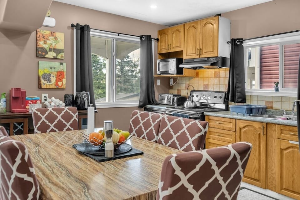 Tastefully decorated kitchen with all the essential appliances, dishes, and cooking utensils. 
