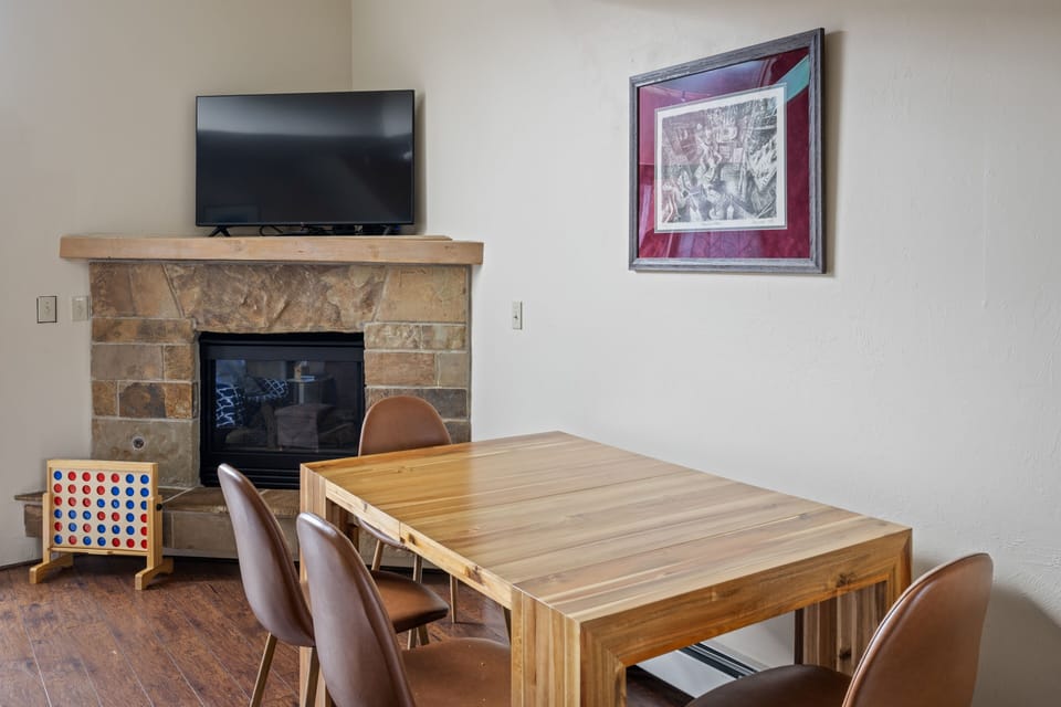 Dining area by sitting area and fireplace
