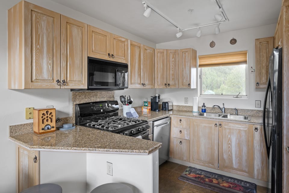 Fully stocked kitchen with additional breakfast bar seating 
