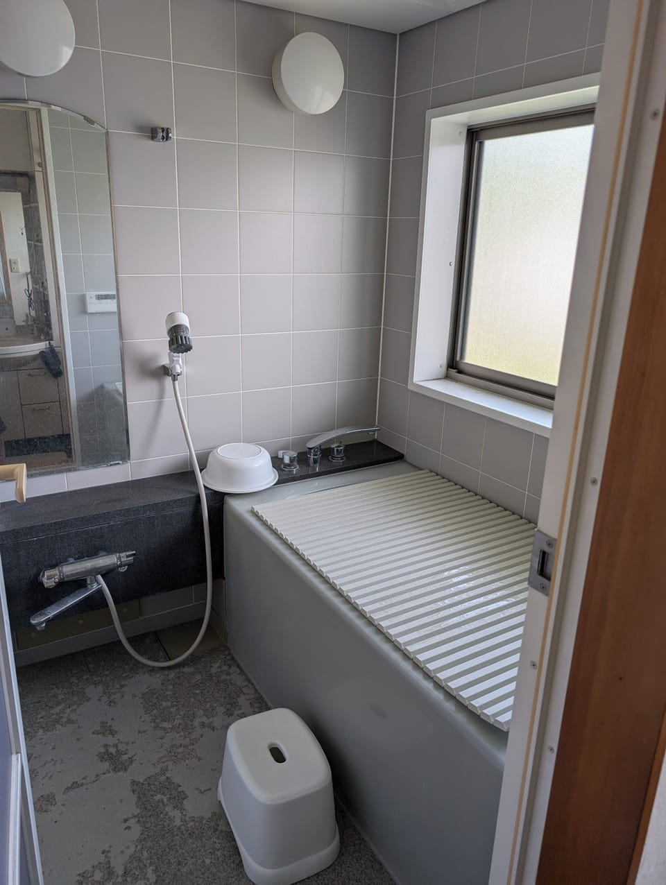 Combined shower/tub, hair dryer, slippers, soap