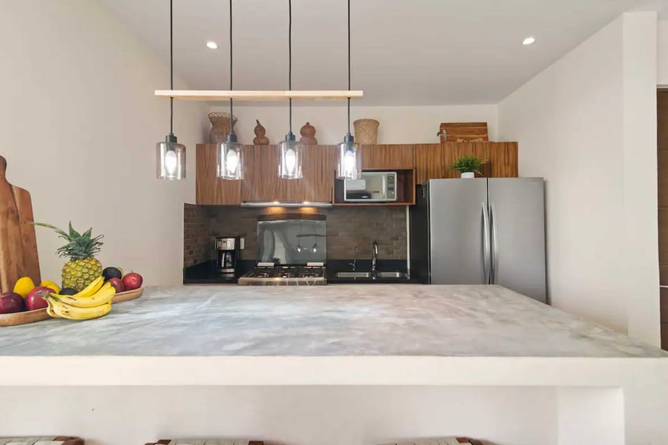 Enjoy our kitchen with a full-sized fridge, freezer, and handy prep island!