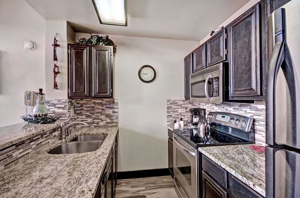 Prepare meals with ease in the fully equipped kitchen with modern appliances, granite countertops, and ample storage space.