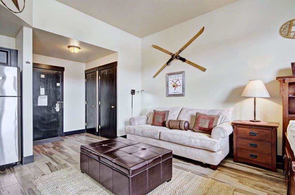 The open living space offers plenty of seating, a flat-screen TV, and rustic décor for a comfortable stay.