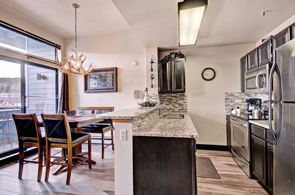 Cook up a storm in the modern kitchen featuring stainless steel appliances, granite countertops, and a spacious dining area.