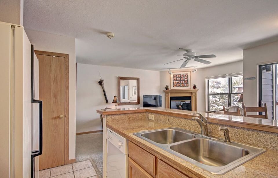 The spacious kitchen boasts modern appliances, a large sink, and plenty of counter space, perfect for preparing meals and entertaining.