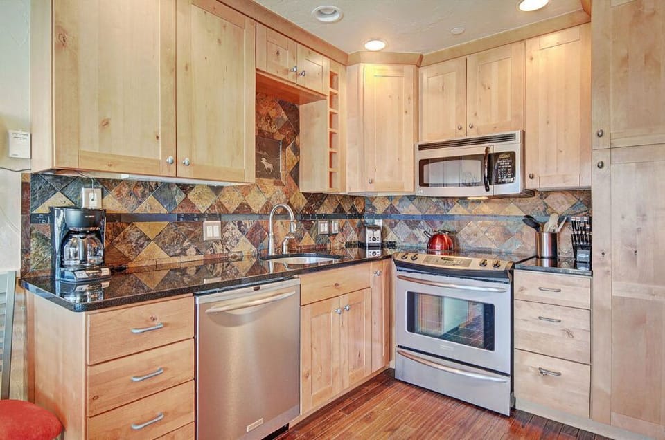 Fully-equipped kitchen with stainless steel appliances and plenty of counter space for preparing meals.