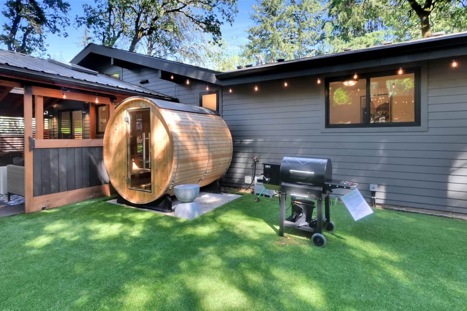 Our grilling station with a wood pellet smoker is next to our barrel sauna.