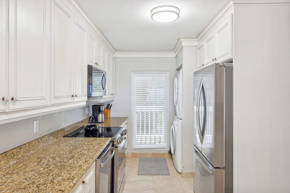 Fully equipped kitchen with all stainless steel appliances.