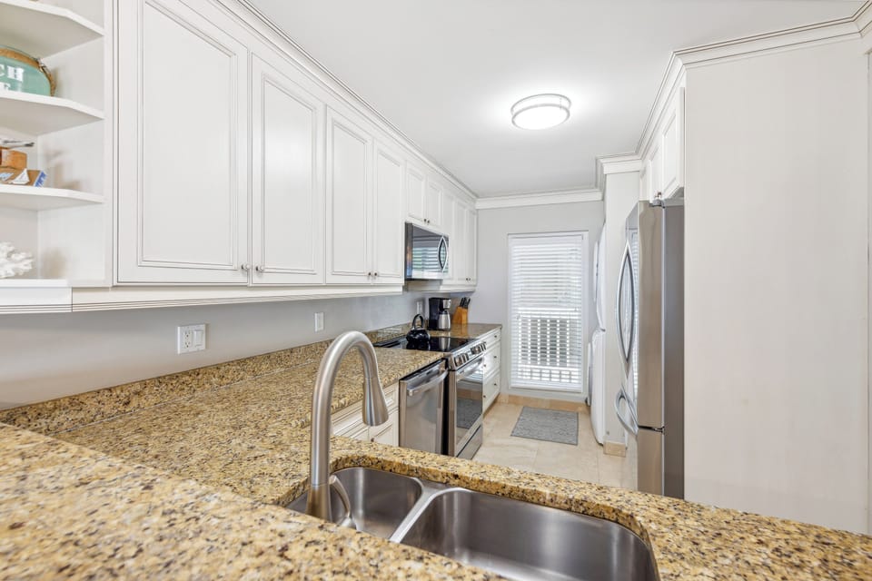Fully equipped kitchen with all stainless steel appliances.