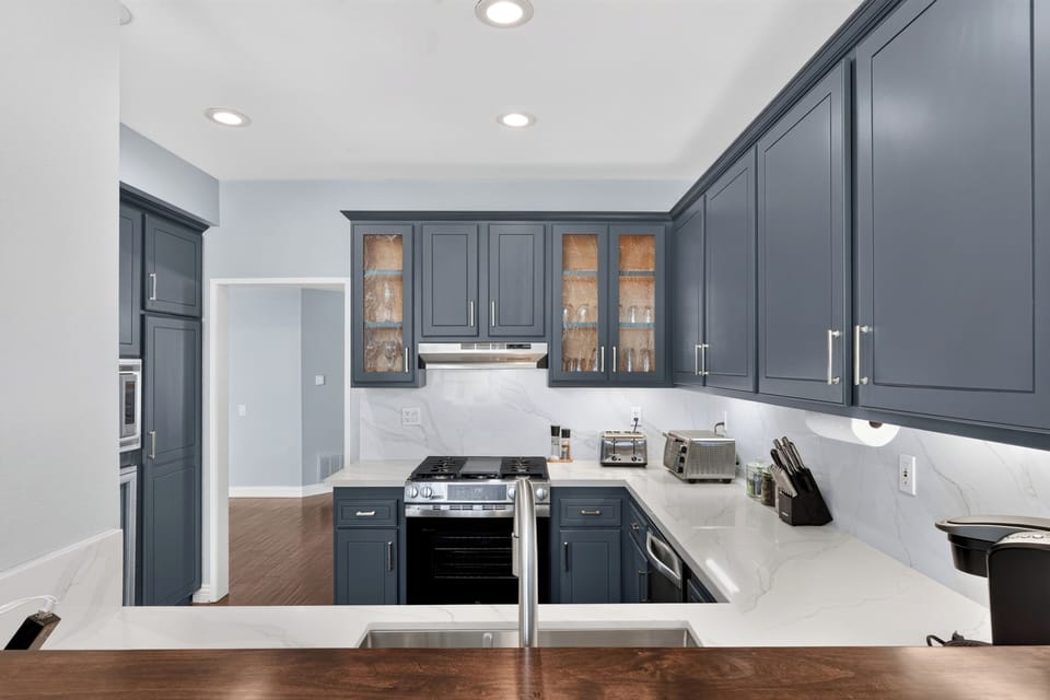 Kitchen is fully equipped and features stainless steel appliances.