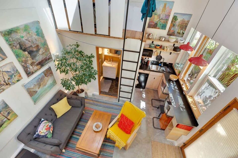 This is a view looking down into the studio kitchenette and dining counter, from the bedroom/office loft upstairs. The ladder goes to a second loft/office that will remain private/not included in this rental.