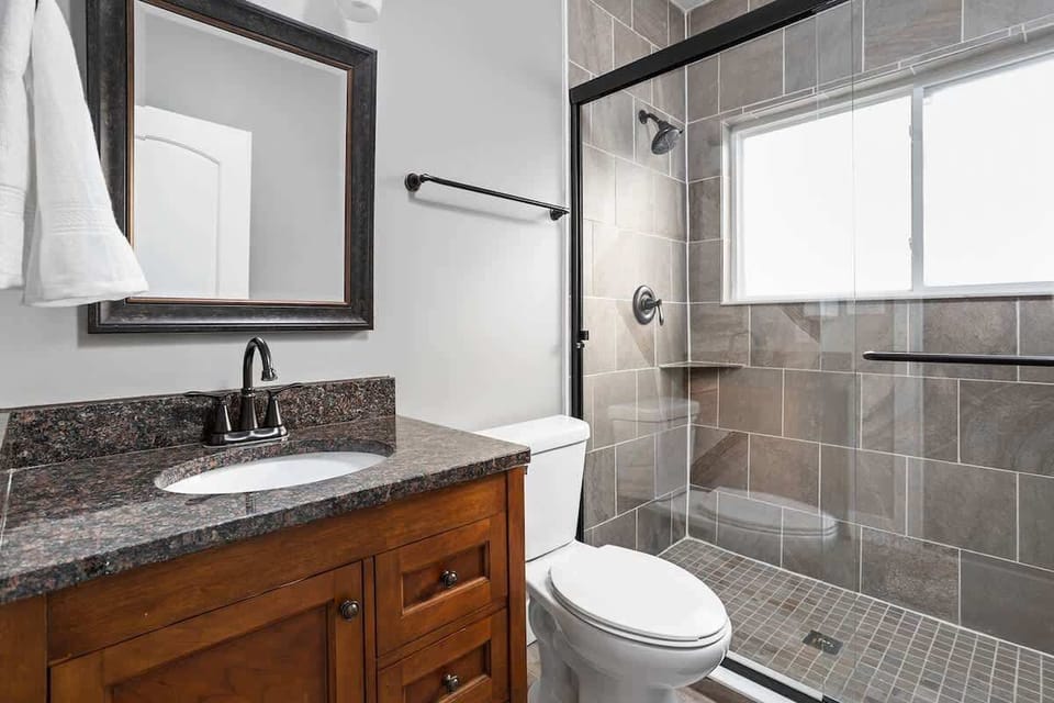 One of our three full bathrooms- newly renovated beautiful walk-in shower with new tiles and glass door!