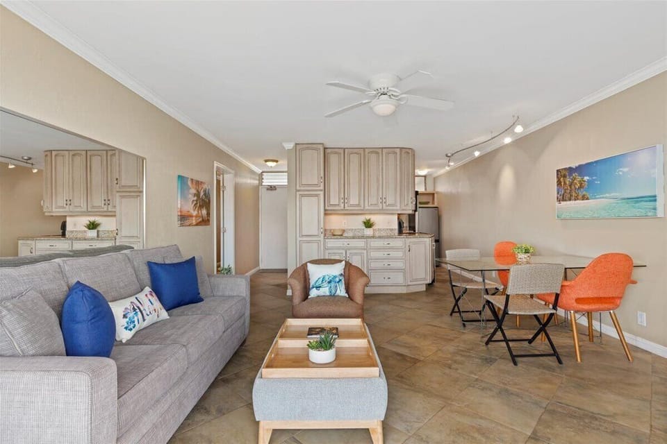 Relax in your bright, open-plan living space with comfy seating, a fully equipped kitchen, and coastal charm—perfect for unwinding after a day at the beach.