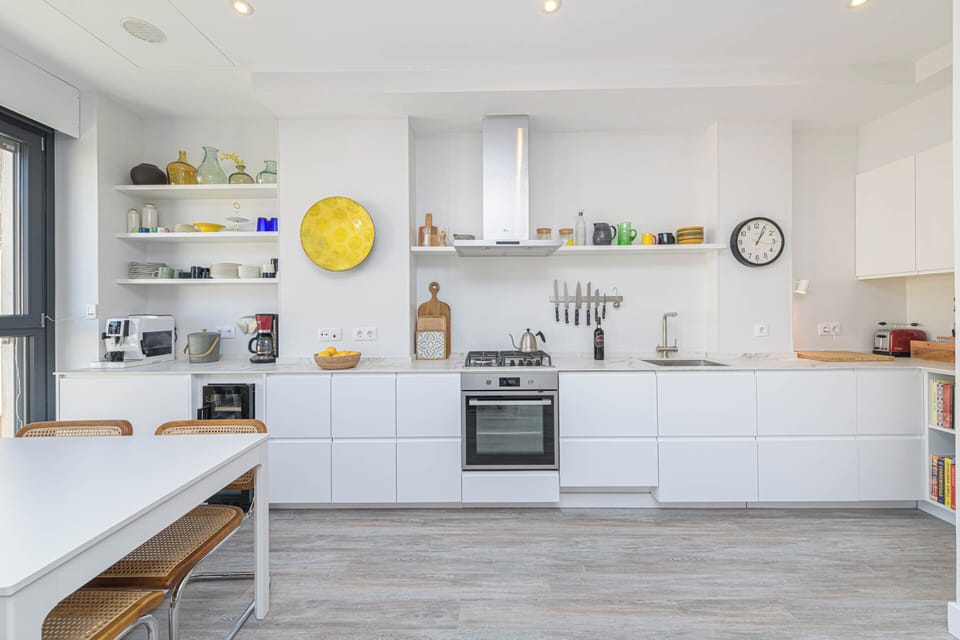Deluxe Apartment, City View | Private kitchen | Electric kettle, toaster, highchair, cleaning supplies