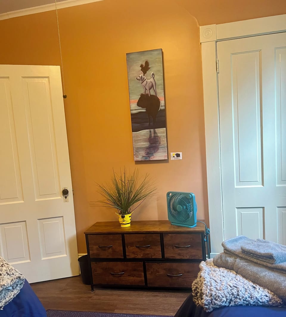 Fun modern art in this vintage room with twin beds.