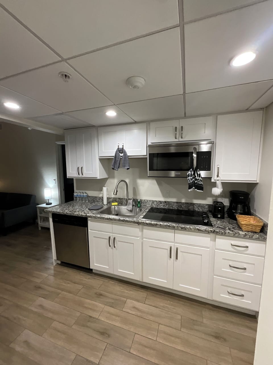 Full kitchen with cookware, utensils, full refrigerator, stove and dishwasher.