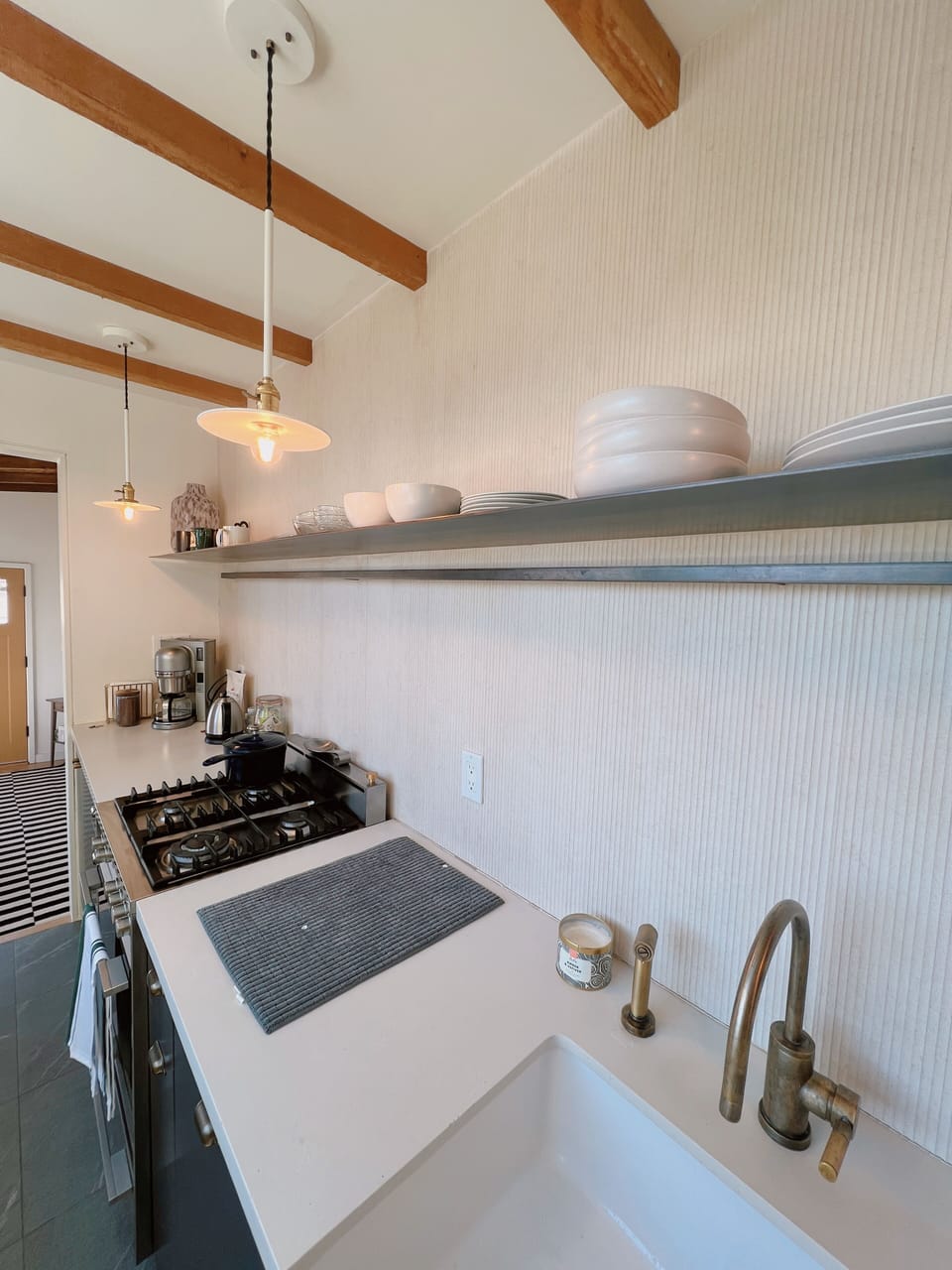Kitchen with farm sink, live brass faucets.
