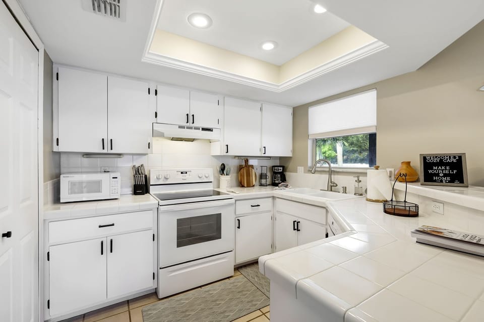 Kitchen featuring ceramic tile countertops and everything you need to serve up great meals.