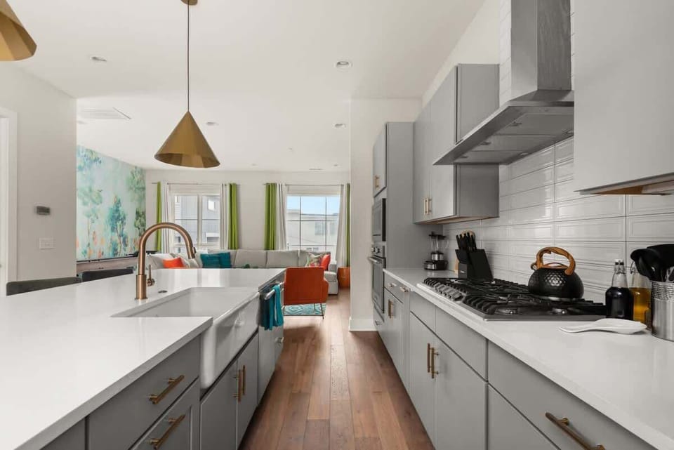 Fully Equipped Kitchen with Modern Appliances, open to the living room and the dining area
