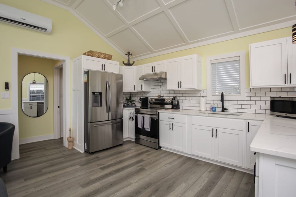 Kitchen with fridge, dishwasher, stove and stocked for your cooking convenience