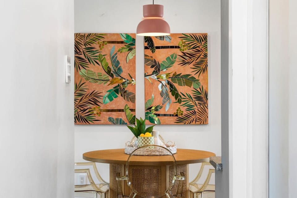 Stylish indoor vignette w/ bold wall art, warm wood tones & curated decor.