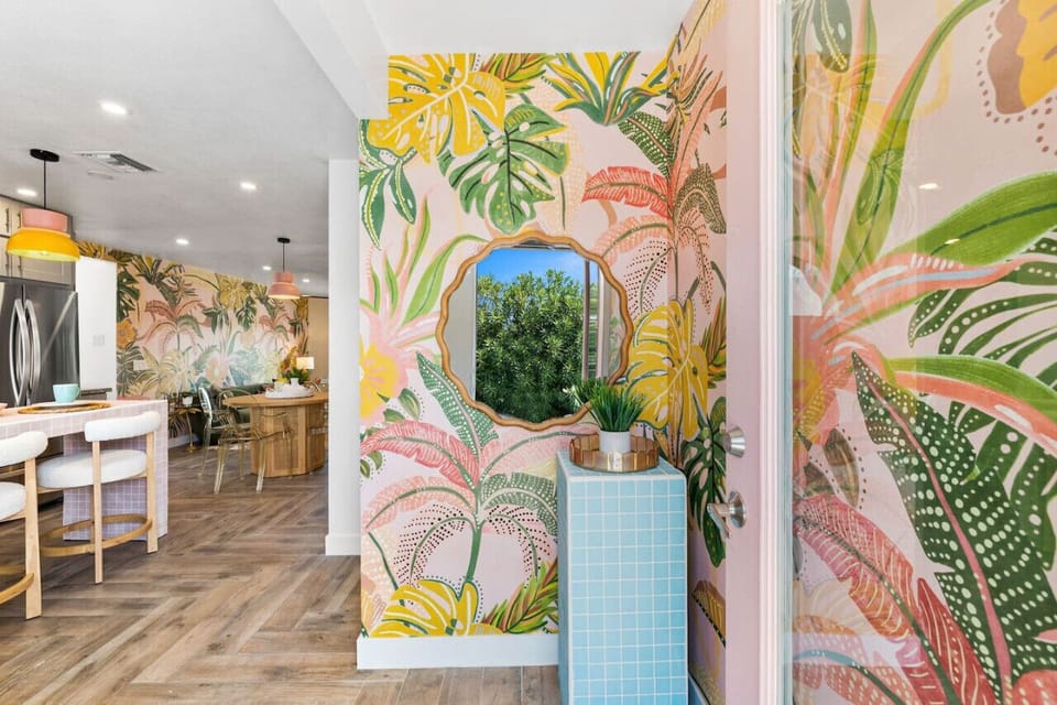 Eye-catching entry corner w/ bold mural, arched mirror & playful desert flair.