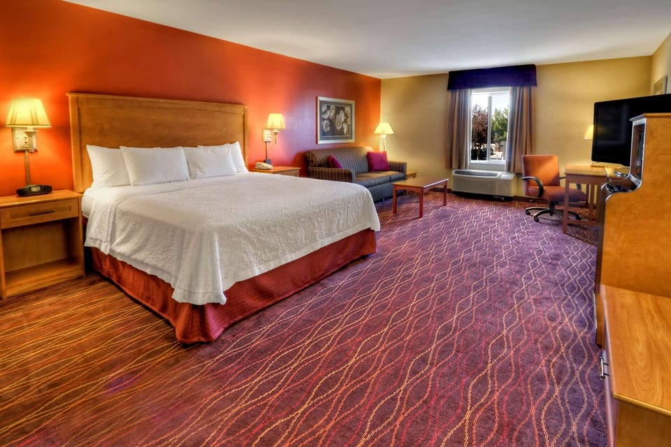 Premium bedding, desk, laptop workspace, blackout drapes