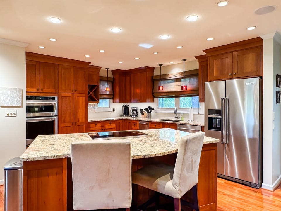 Custom designed kitchen with granite island and island seating to enjoy family cooking with all the extra kitchen amenities at Pointer Haus.