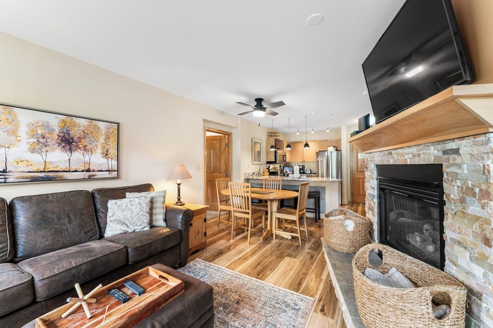 Unwind in your cozy open-plan retreat with a crackling fireplace, plush leather seating, and a fully equipped kitchen—perfect for memorable mountain evenings.