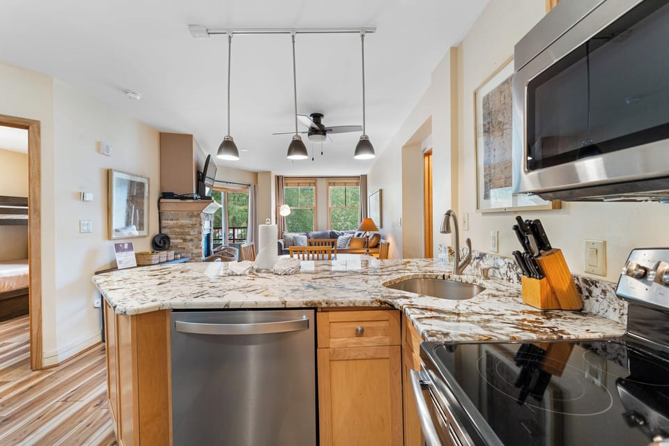Your gourmet kitchen features granite countertops, stainless appliances, and flows seamlessly into the bright living area—perfect for cooking together.
