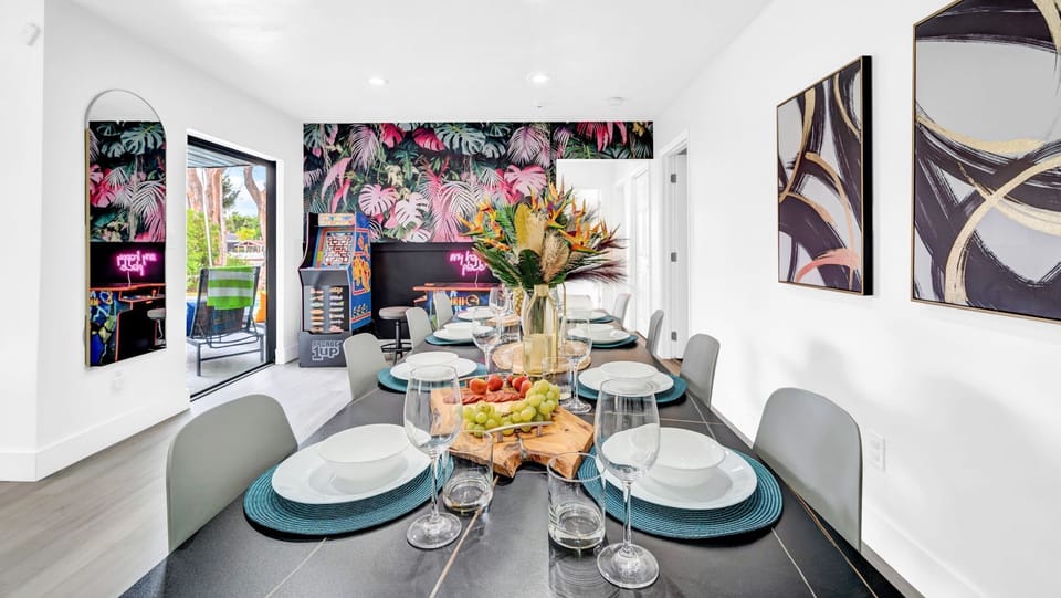 Sophisticated dining area featuring tropical decor, arcade entertainment, and seamless indoor-outdoor flow. Ultimate entertainment space #TropicalLiving #ArcadeEntertainment #LuxuryDining #IndoorOutdoor #GamingRoom #TropicalDecor #EntertainmentSpace 