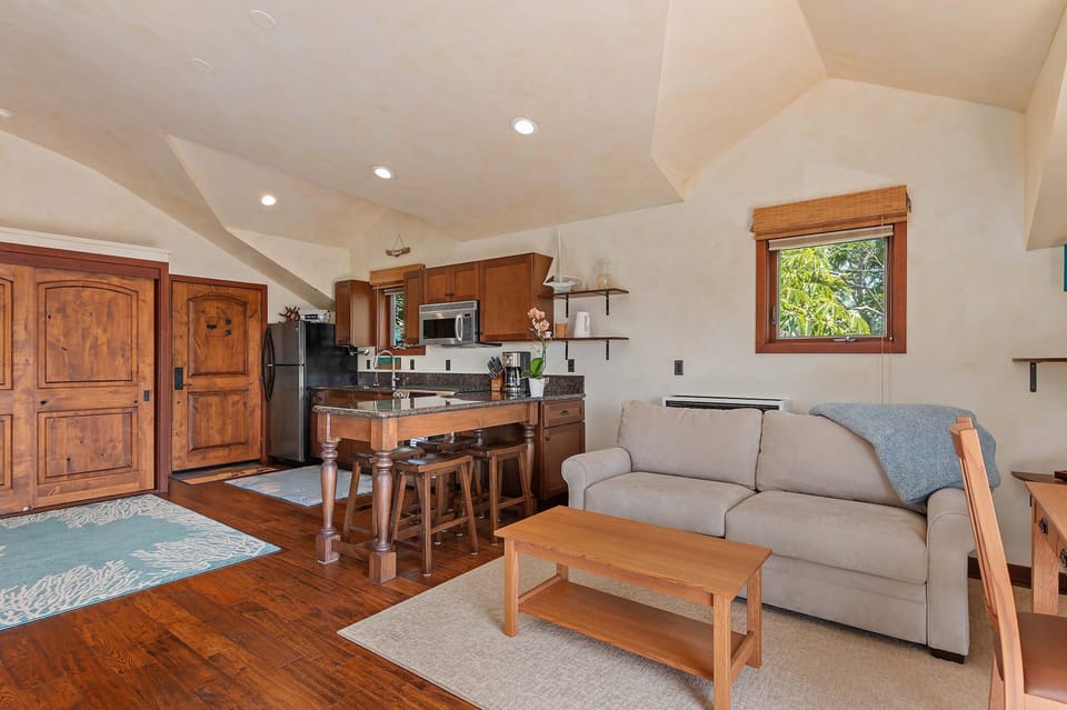 Living room with loveseat, flat screen TV, and ocean view