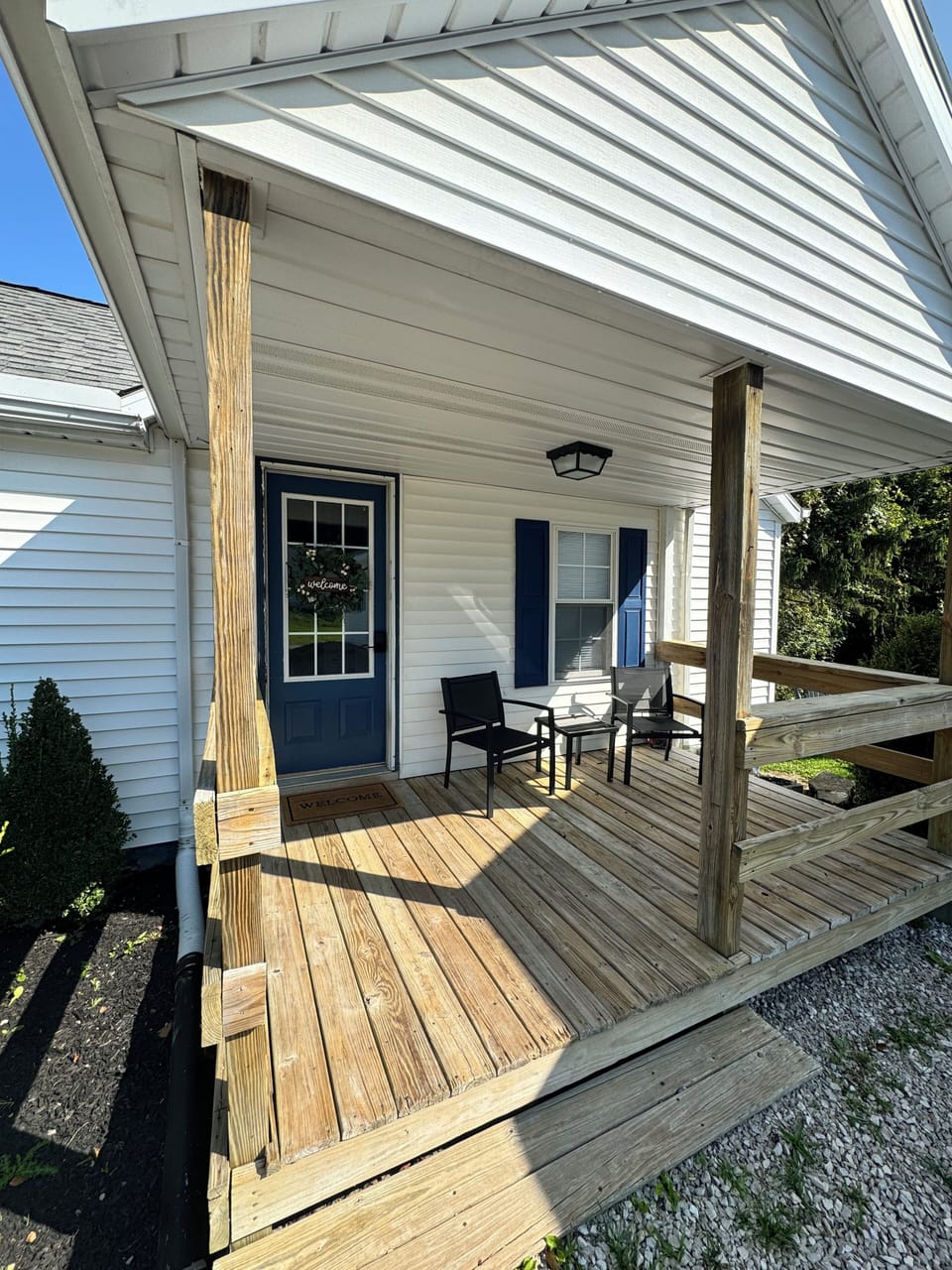 Side porch and main guest entrance with seating area for guests to enjoy.