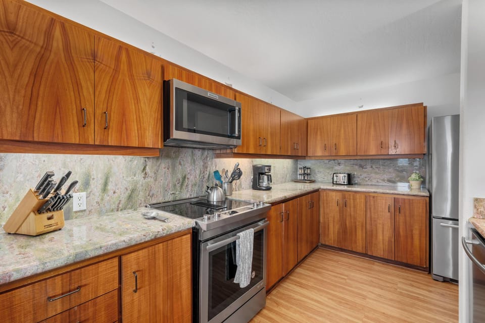 Your fully equipped kitchen has everything you need to whip up a quick breakfast or prepare a memorable meal, with sleek granite counters and warm wood cabinetry inviting you to feel right at home.