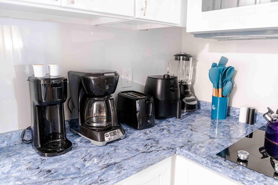 Full kitchen with refrigerator, freezer, stove, microwave, toaster, coffee maker