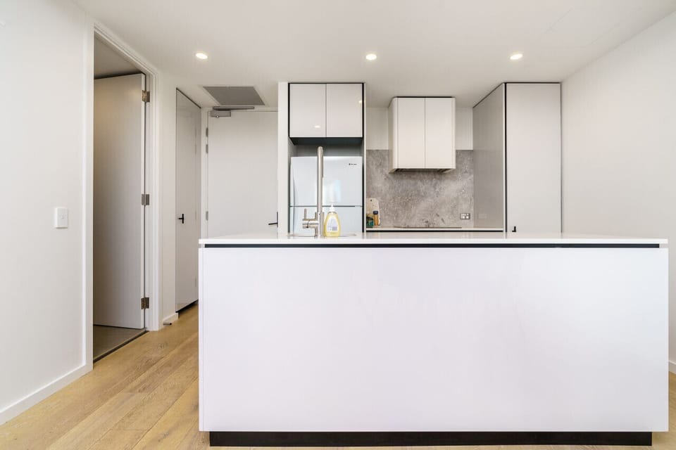 Discover the sleek design of our modern kitchen, equipped with top-of-the-line appliances that make cooking and meal preparation a breeze. Enjoy both style and functionality in this well-appointed space.