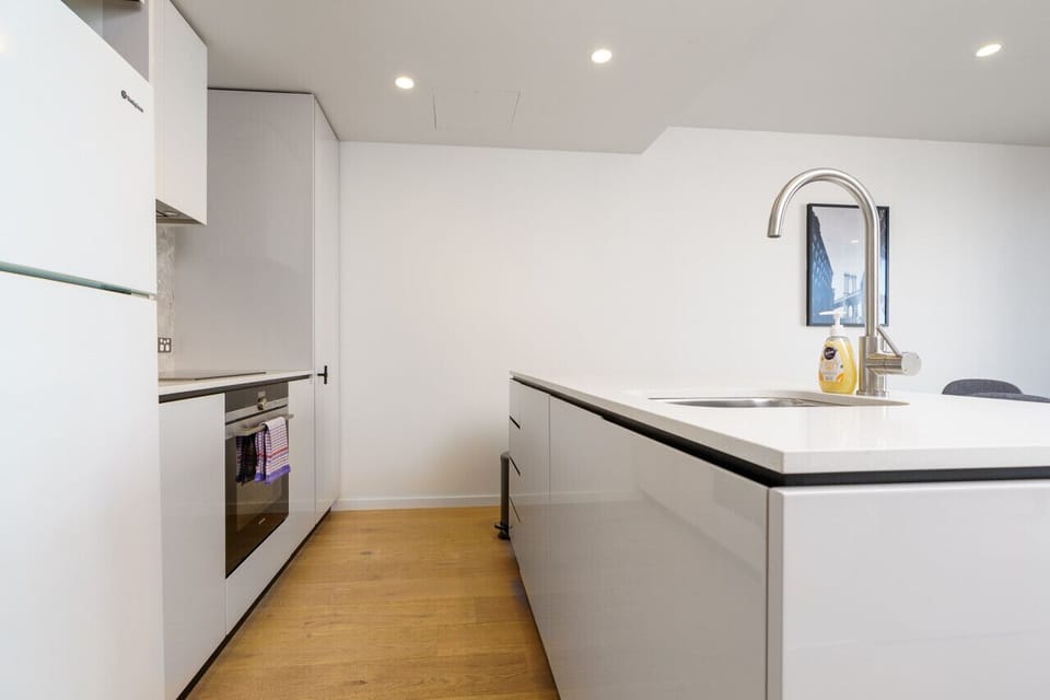 Discover the sleek design of our modern kitchen, equipped with top-of-the-line appliances that make cooking and meal preparation a breeze. Enjoy both style and functionality in this well-appointed space.