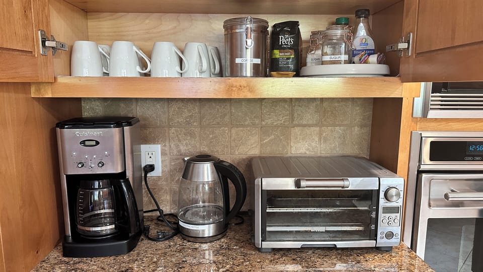 Coffee maker and electric kettle,  Coffee, tea, sugar and cream are available.