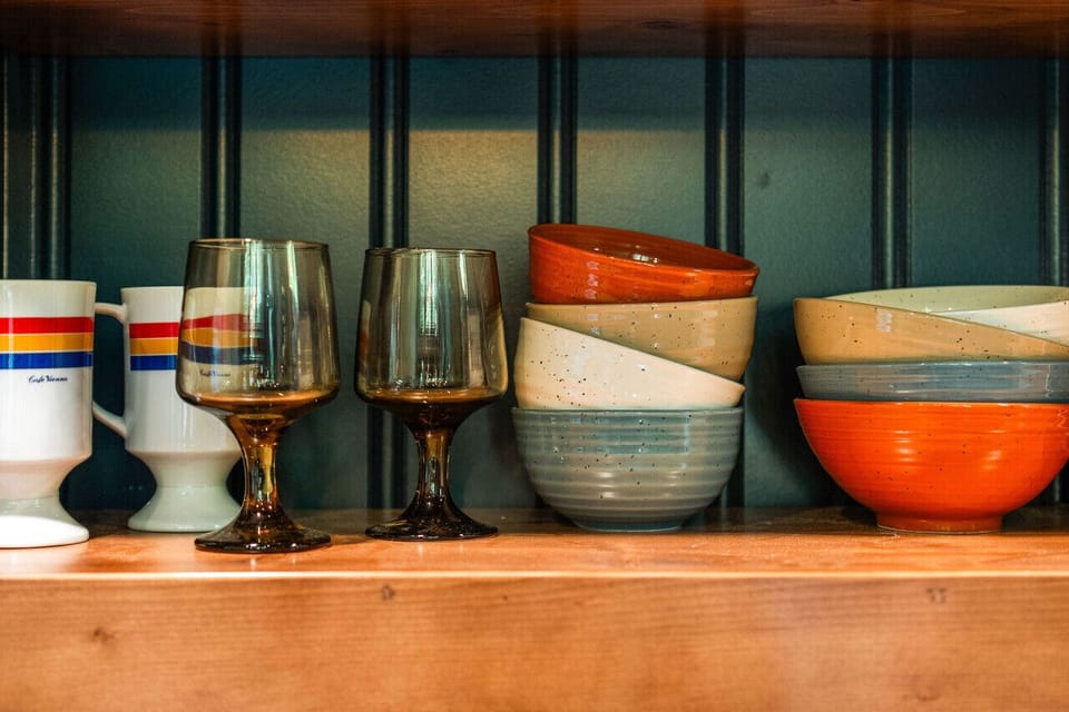 The kitchen features a two-burner electric cooktop, ice maker, microwave, toaster, blender, dishwasher, and refrigerator, along with a coffee maker that uses our custom Hideout coffee blend.