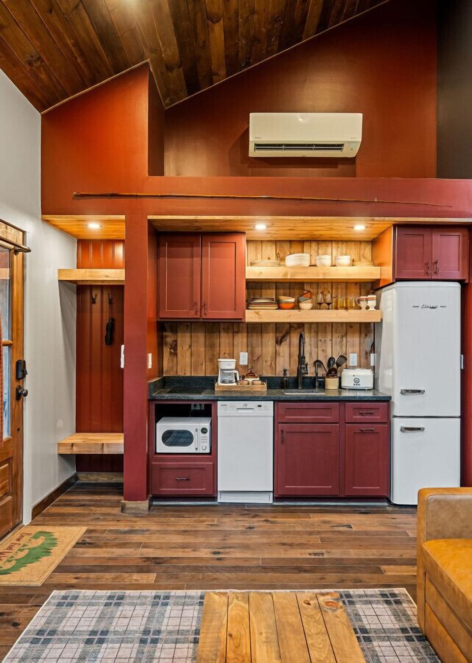 The kitchen features a two-burner electric cooktop, ice maker, microwave, toaster, blender, dishwasher, and refrigerator, along with a coffee maker that uses our custom Hideout coffee blend.