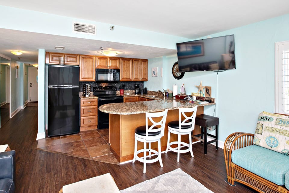 Fully equipped kitchen offering a full size refrigerator with ice-maker, stove, disposal, microwave and dishwasher.