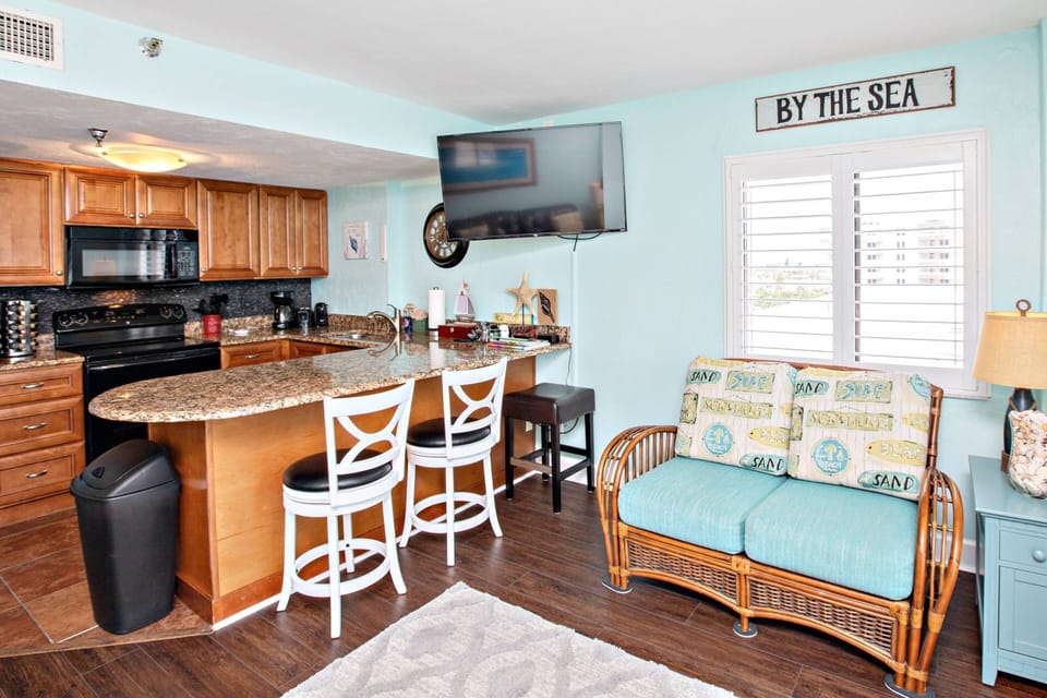 Kitchen breakfast bar comfortably sits 3 people.