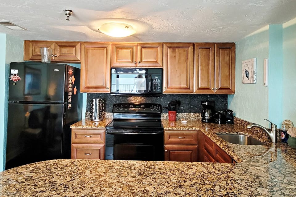 Kitchen is stocked with everything you need to feel at home from spices to silverware.
