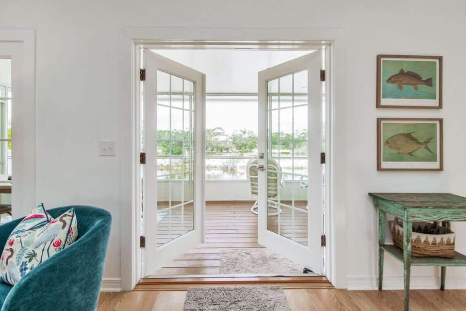 The double doors open to a charming screened-in back deck, offering peaceful canal views and a perfect spot for relaxation and outdoor enjoyment!