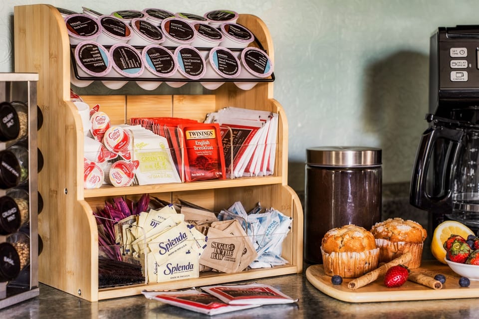 A fully stocked coffee & tea station with pods, sweeteners, and creamers—everything you need for a perfect cup