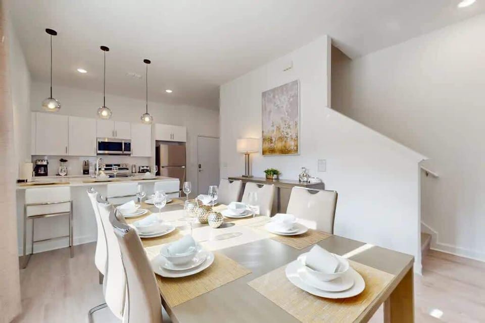 The dining area featured a rustic wooden table surrounded by comfortable chairs, perfect for enjoying meals with family and friends.