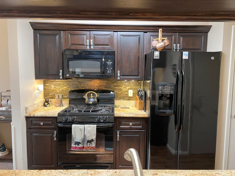 Kitchen stocked with towels, paper towels, dish soap and dishwasher tabs