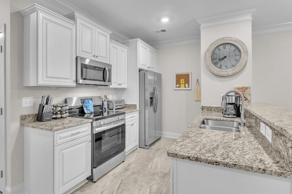 Fully equipped kitchen with stainless steel appliances and spacious counters
