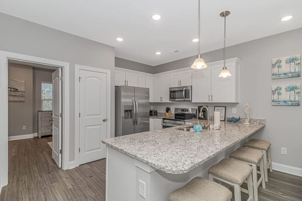 Kitchen with large island and comfortable bar seating ideal for meals, conversation and entertaining